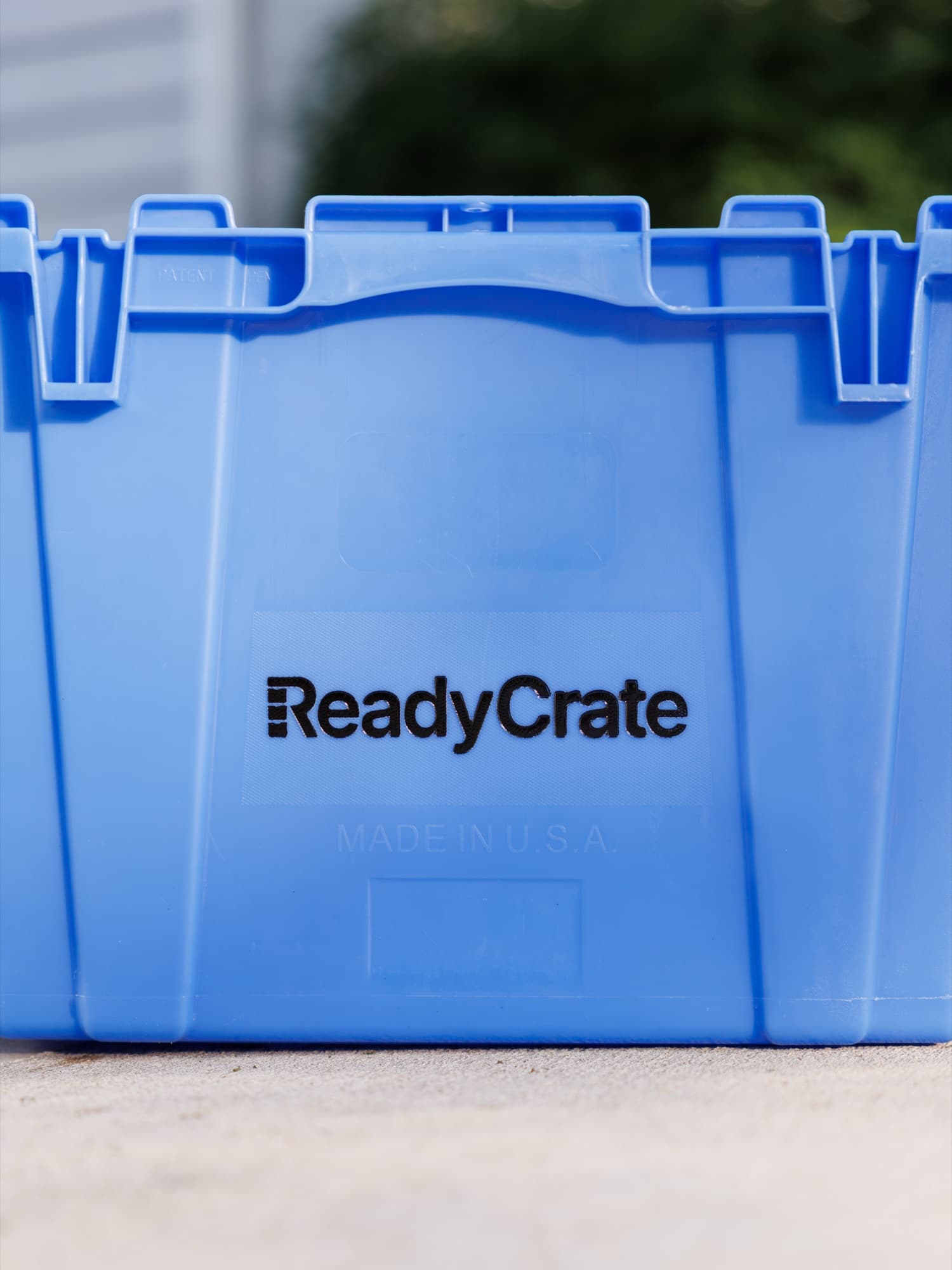 Close-up of the ReadyCrate wordmark on the side of a blue tote, with Made in U.S.A. embossed beneath it